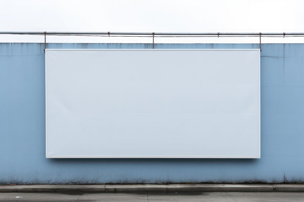 A blank sign white wall blue.