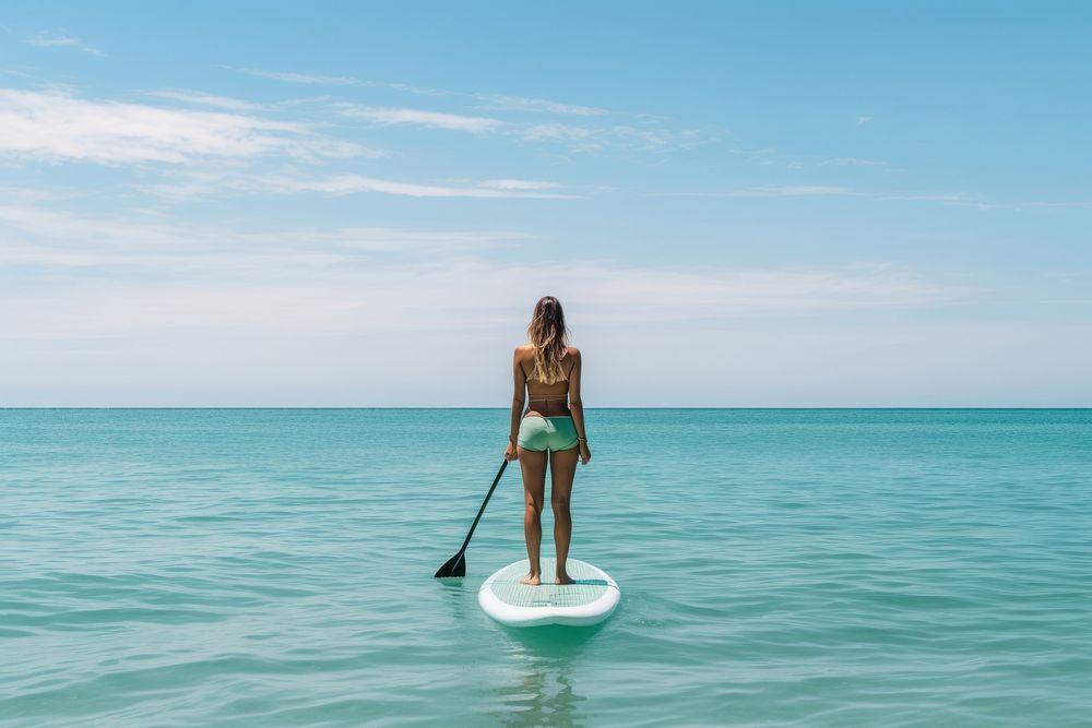 Ocean waves Woman standing paddle.
