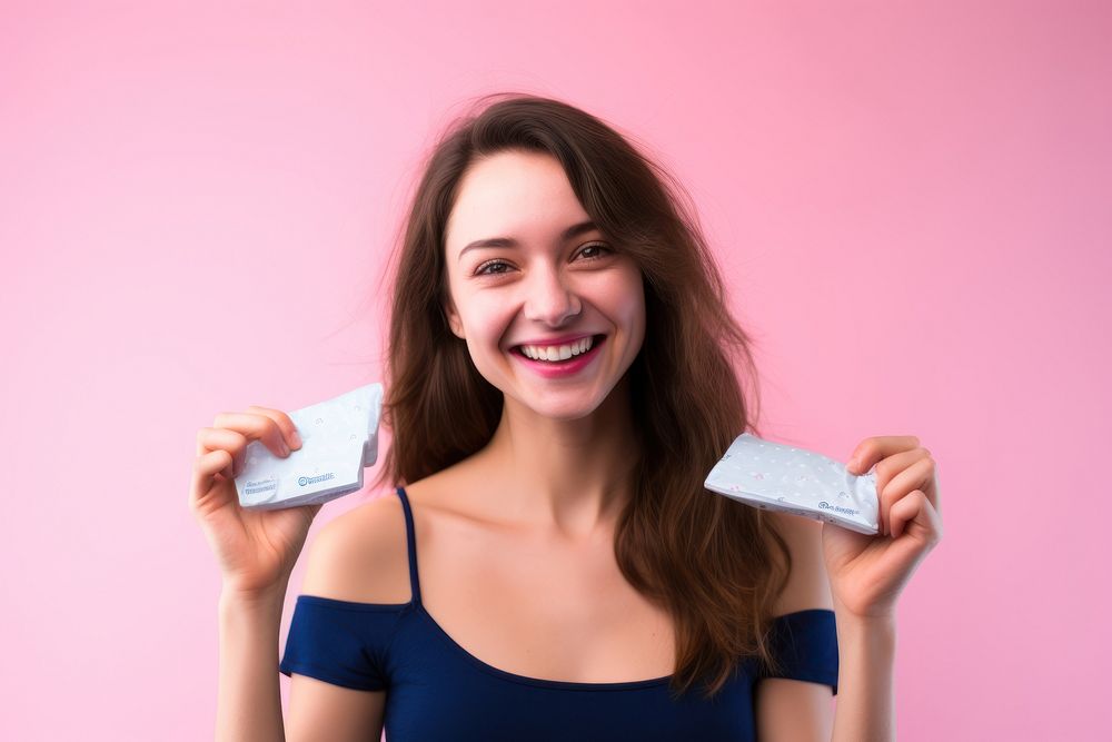 Pink background menstrual pad Young woman smile.
