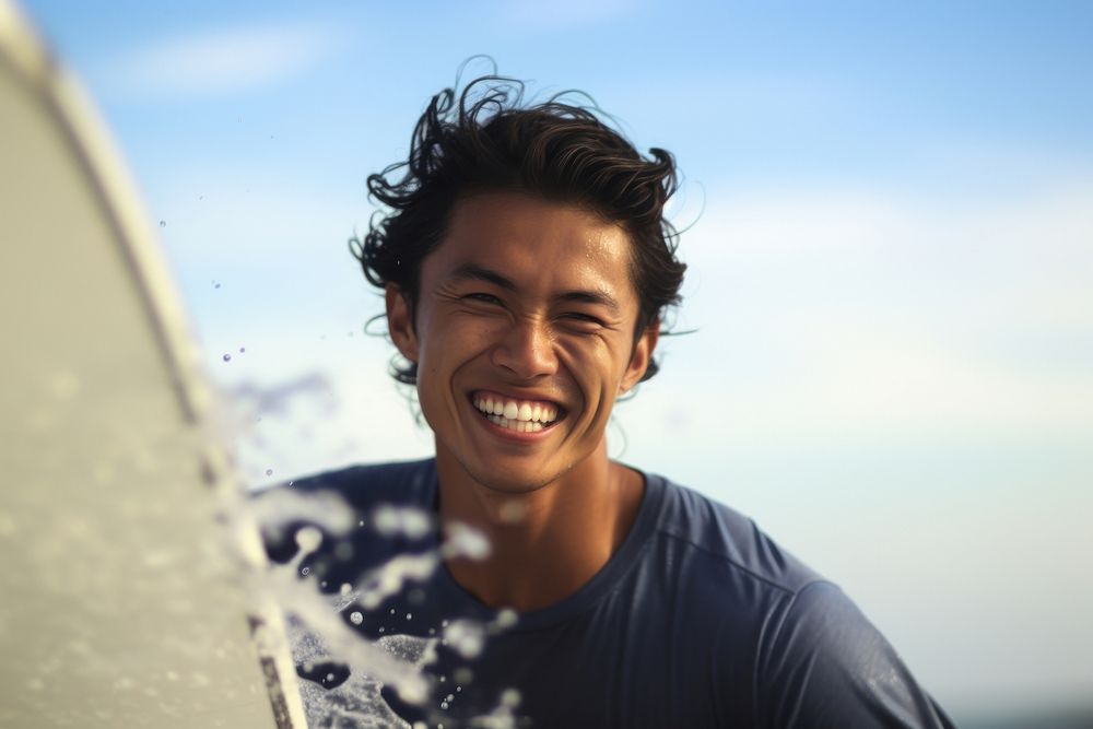 Asian surfer surfing laughing portrait outdoors.