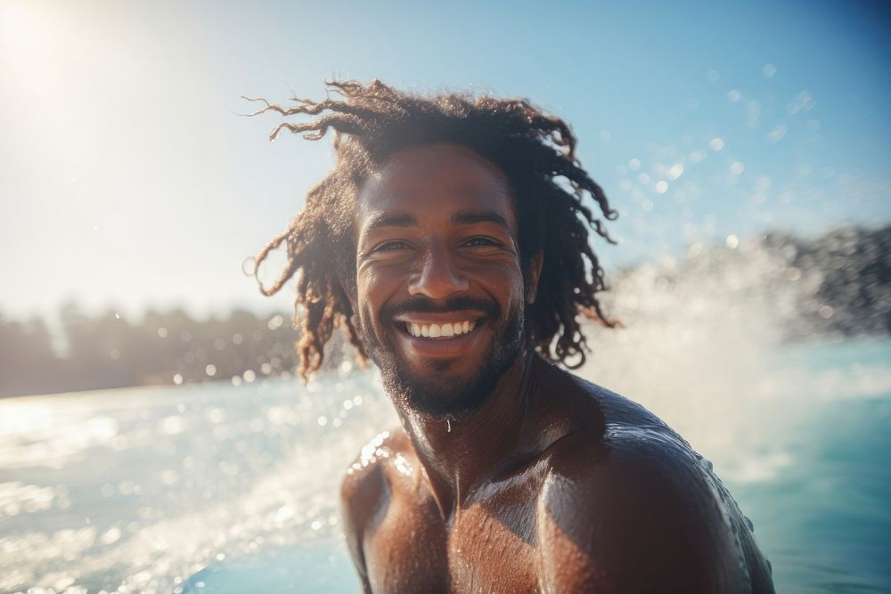 Black male surfer surfing laughing smiling smile.