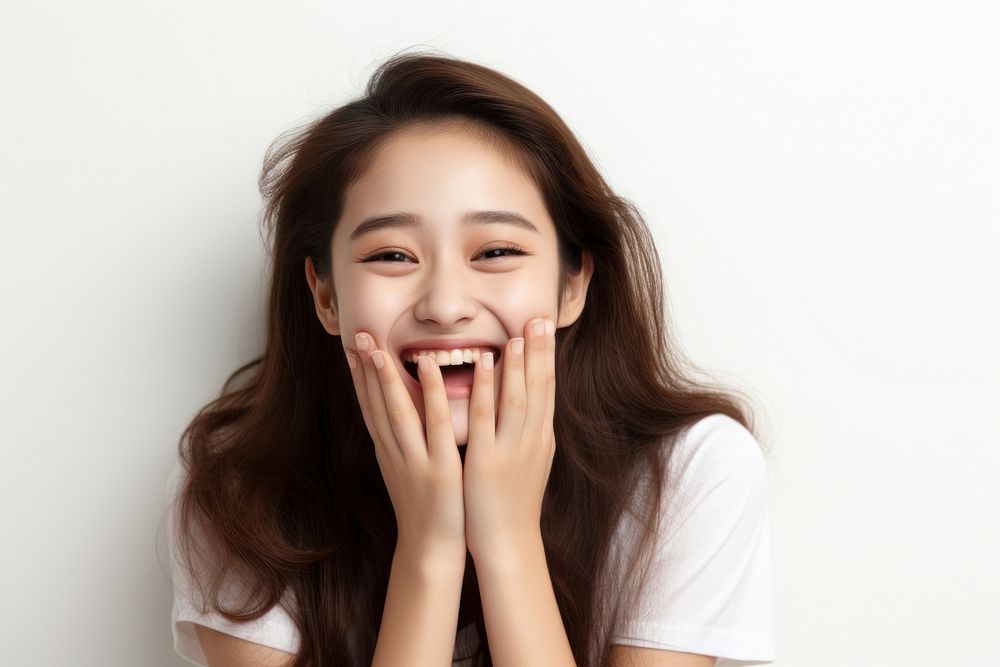 Korean girl rubbing face laughing portrait smiling.