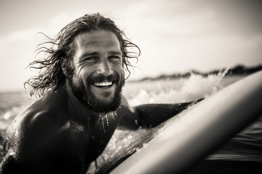 Surfer surfing portrait outdoors smiling.