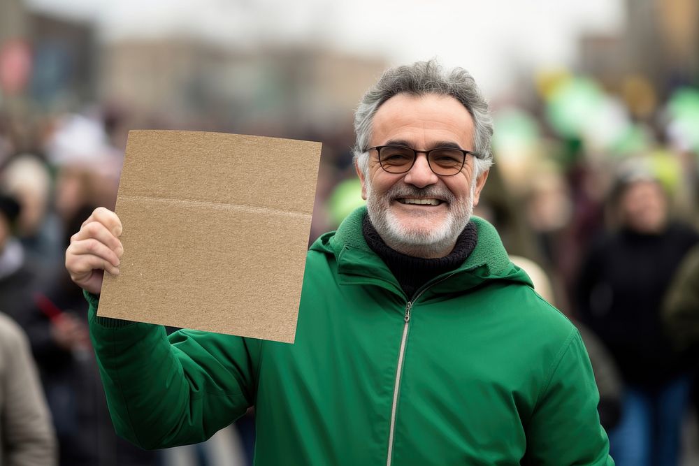 Middle-aged man holding a blank cardboard sign