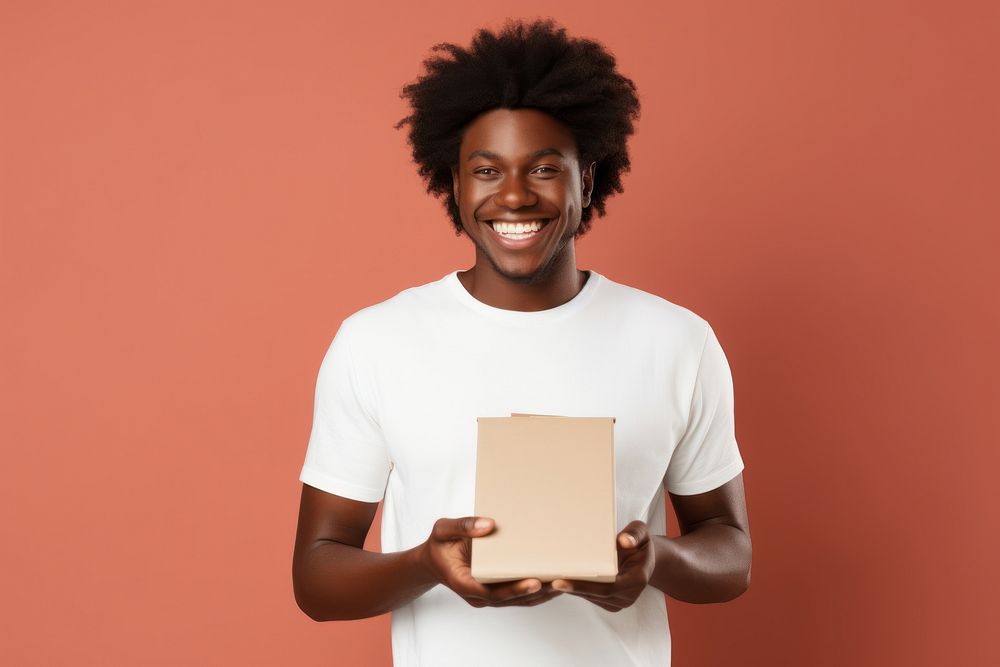 African american man in white t-shirt holding happy box.