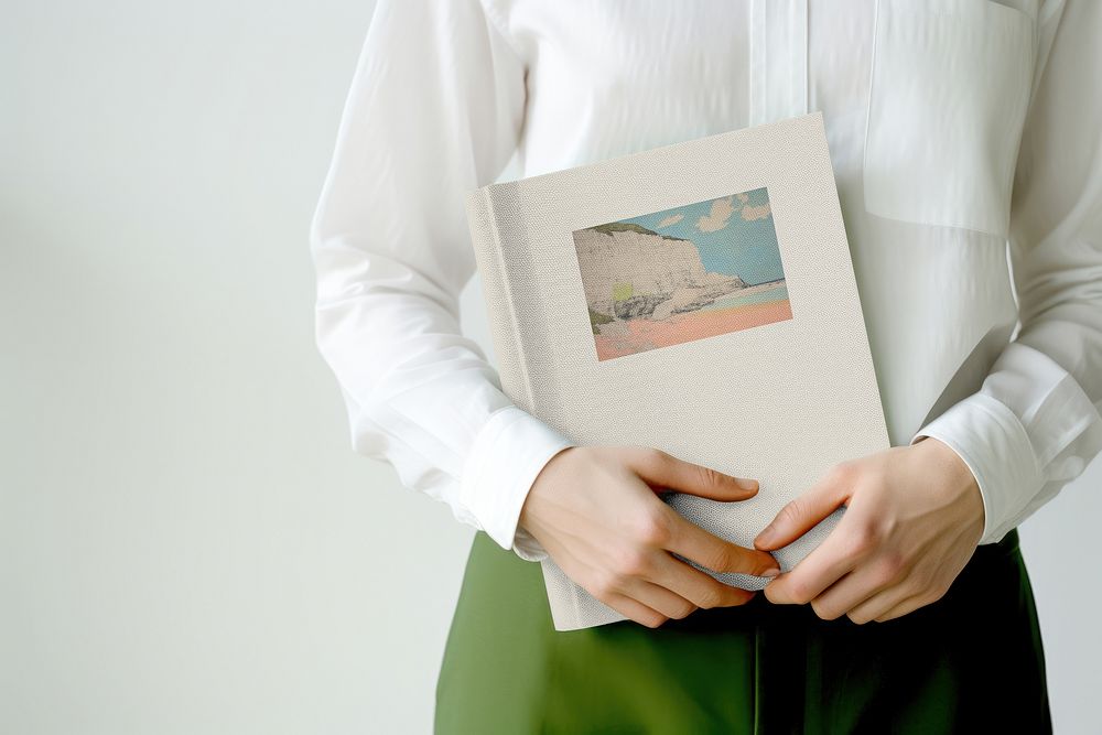 Woman holding hardcover book