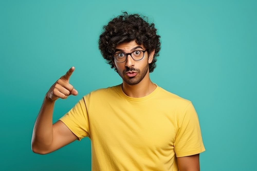 Indian man with curly hair glasses portrait standing.
