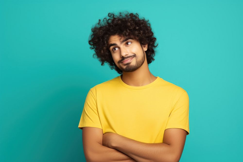 Indian man with curly hair portrait standing t-shirt.