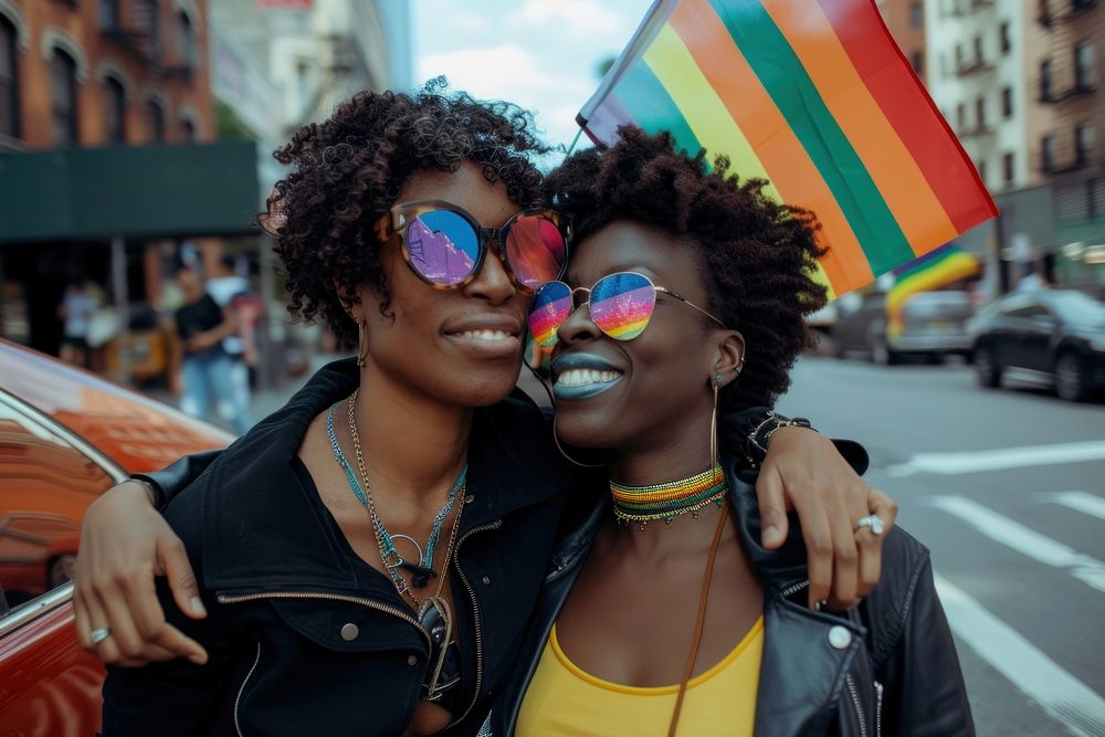 Black couple lesbian woman with gay pride flag on the street glasses parade adult.