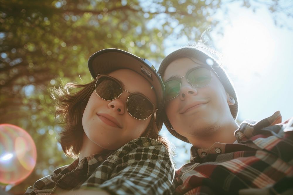 Couple of happy young american adult picnic sun photography sunglasses.