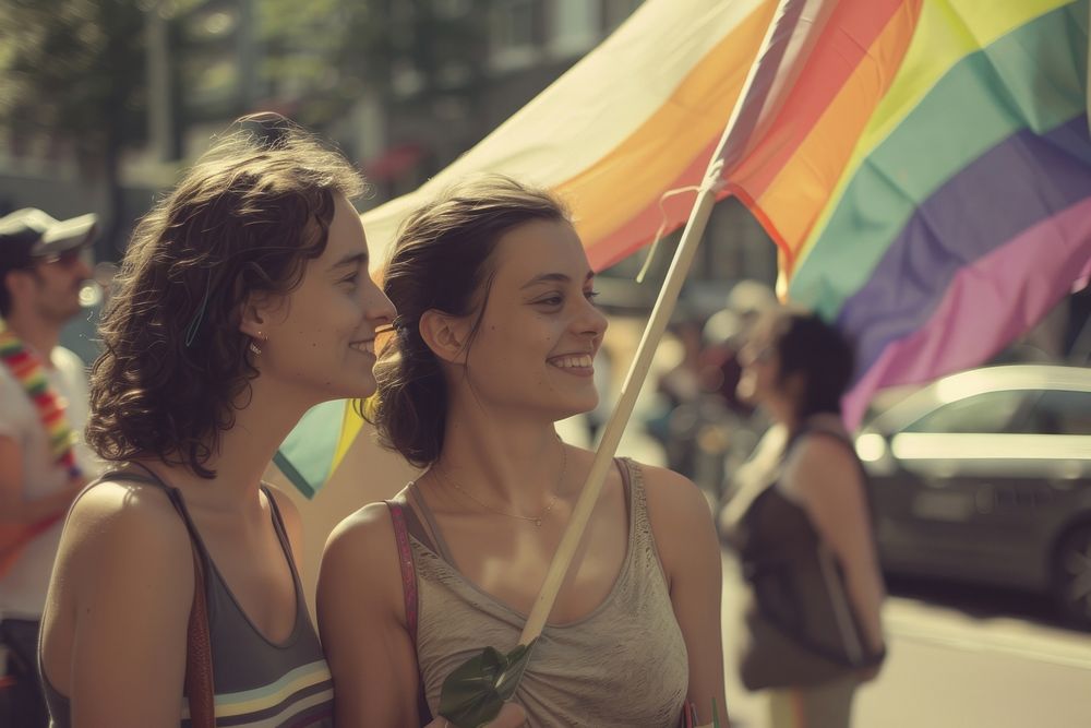 Couple lesbian woman with gay pride flag on the street photography portrait vehicle.