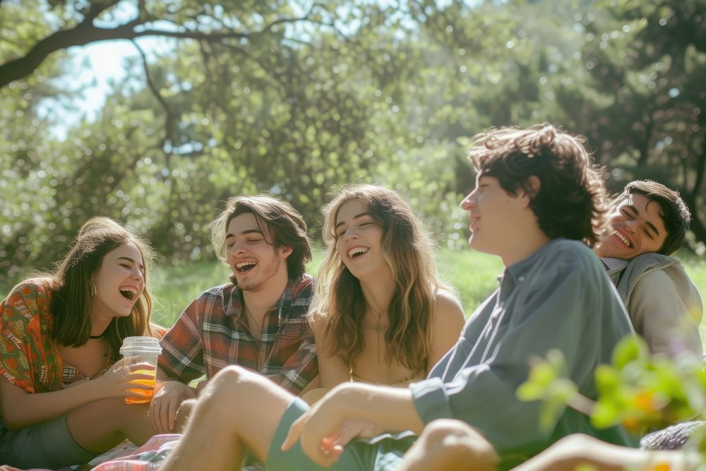 Group of happy young adult picnic laughing outdoors plant.