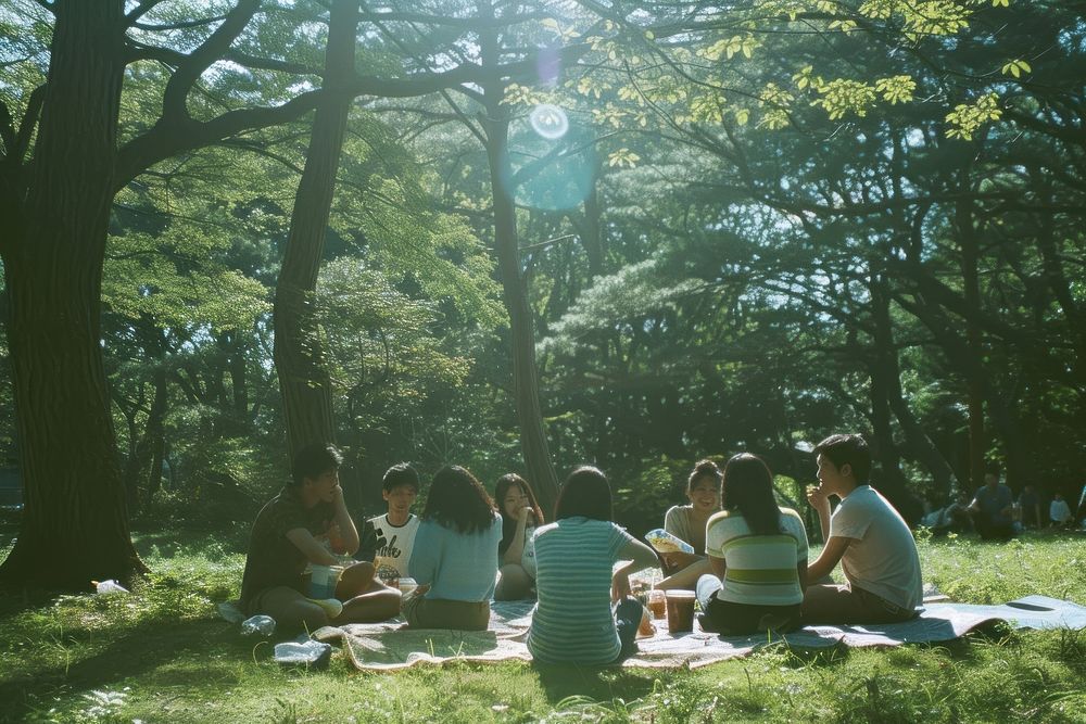Group of happy young japanese adult picnic park sunlight outdoors.