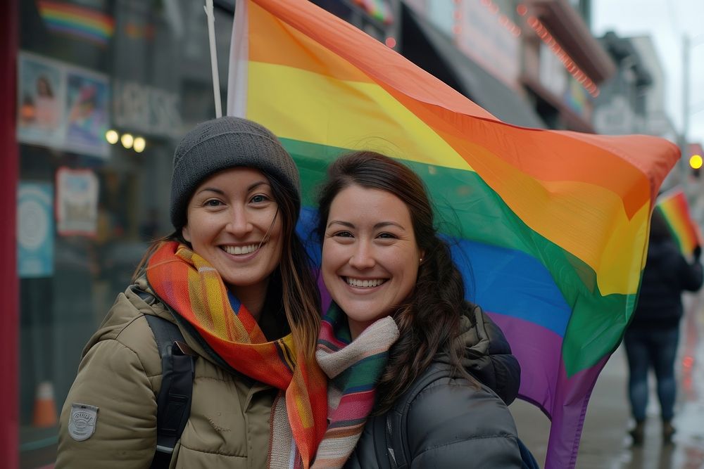 Happy couple lesbian woman with gay pride flag on the street adult scarf togetherness.
