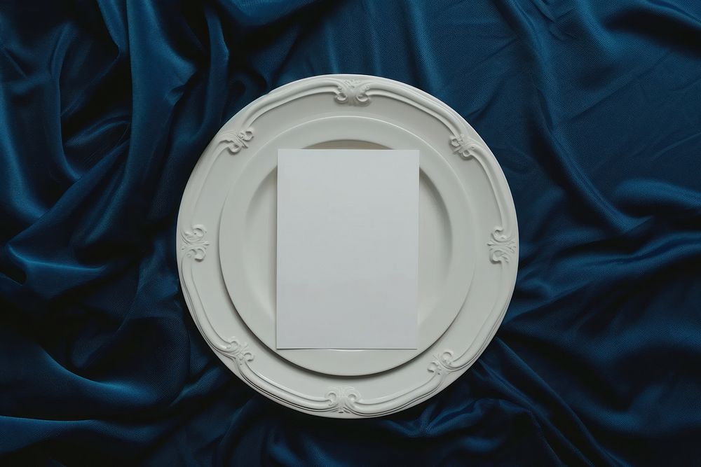 Paper blank menu card on white plate porcelain blue tableware.