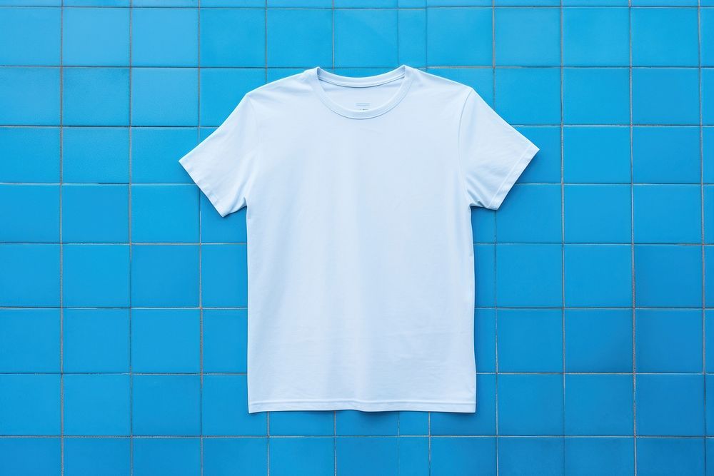 A t-shirt is on a blue tile sleeve wall architecture.