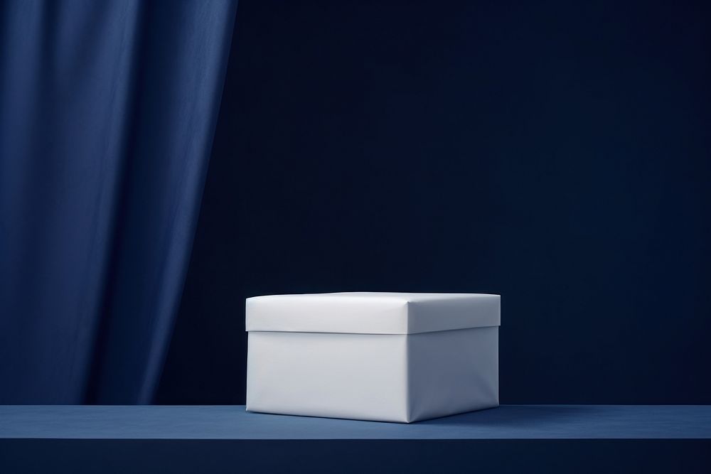Two stacked white boxes on a podium backdrop blue simplicity porcelain.