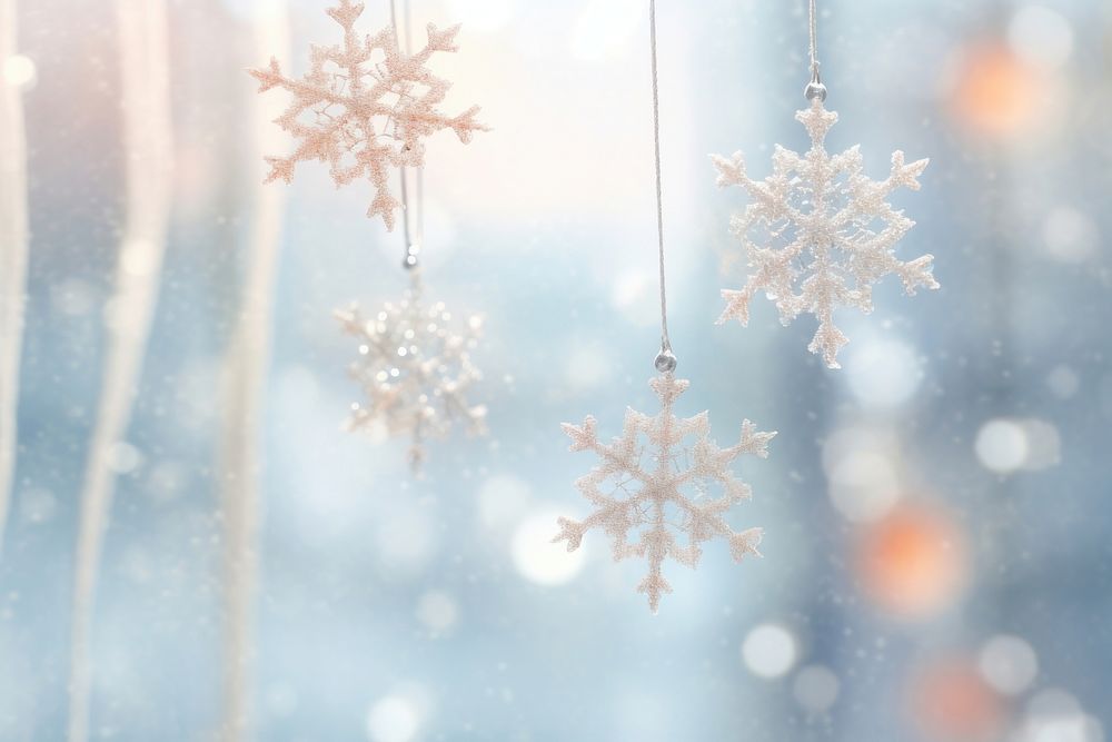 Elegant snowflakes suspended from a luminous bright light white background backgrounds nature illuminated.
