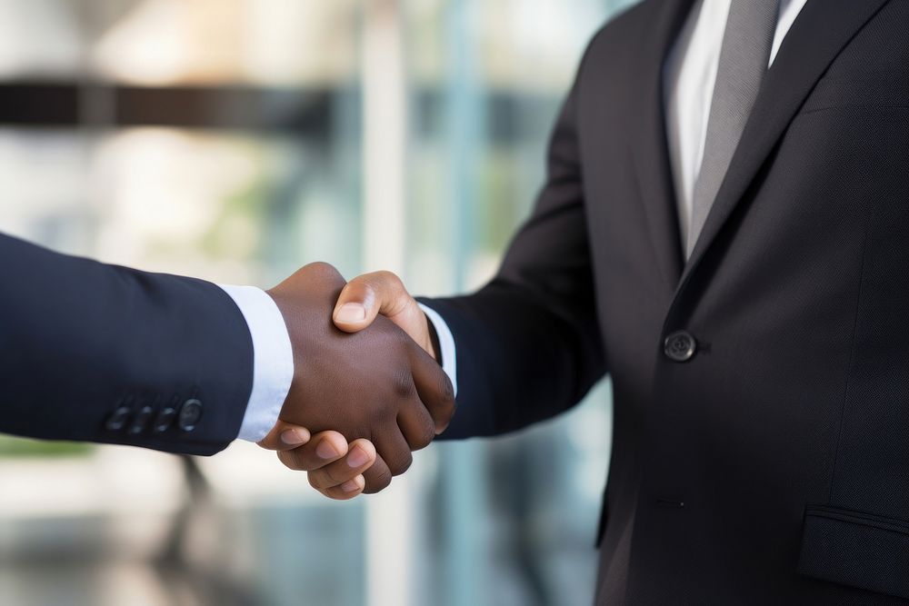 African businessmen shaking hands handshake standing office.