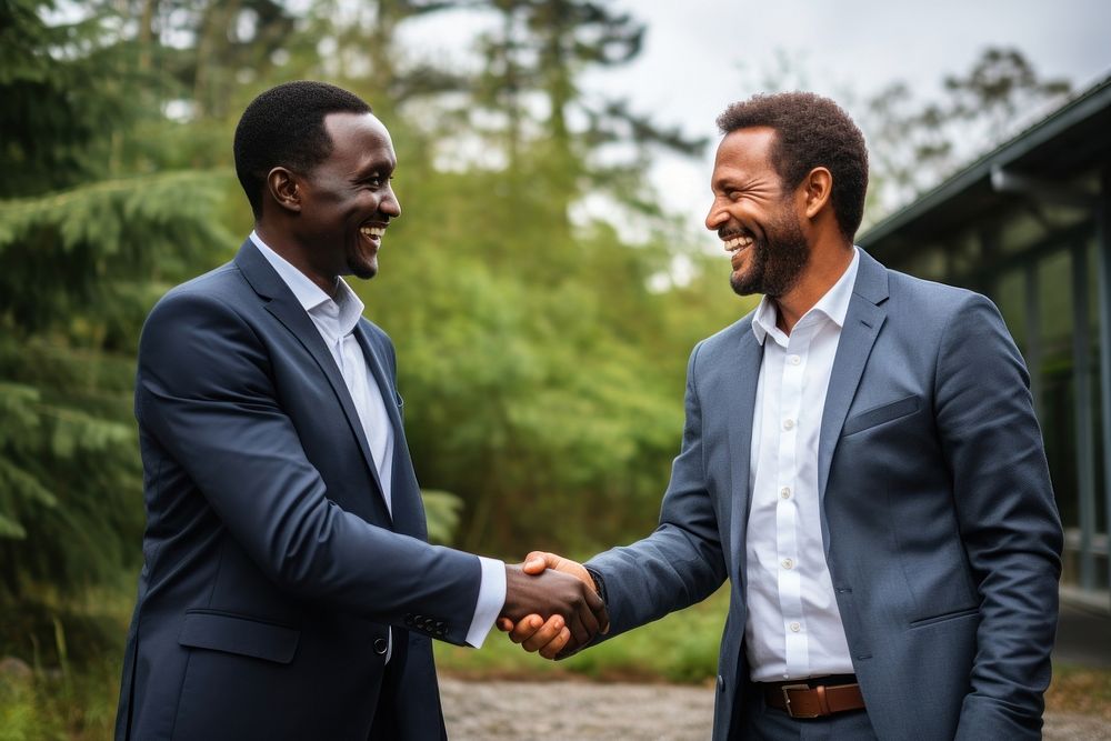 African businessmen shaking hands standing smiling adult.
