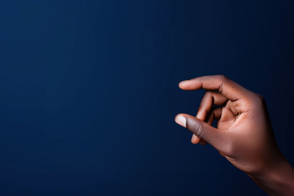 Black hand holding a card finger photo blue.