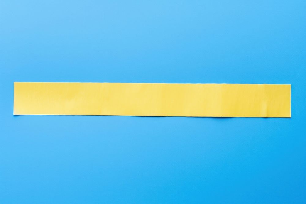 Yellow pattern adhesive strip paper blue blue background.