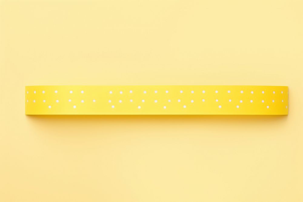 Yellow dot pattern adhesive strip rectangle spotted eraser.