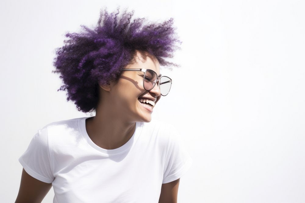 Woman with afro hair and glasses wearing portrait laughing smiling.