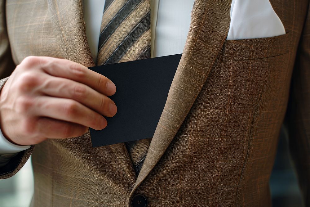 Man getting black card out of suit