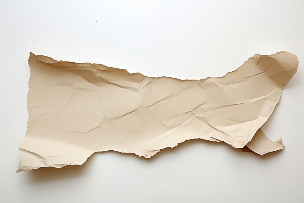 Torn strip of craft paper white background crumpled textured.