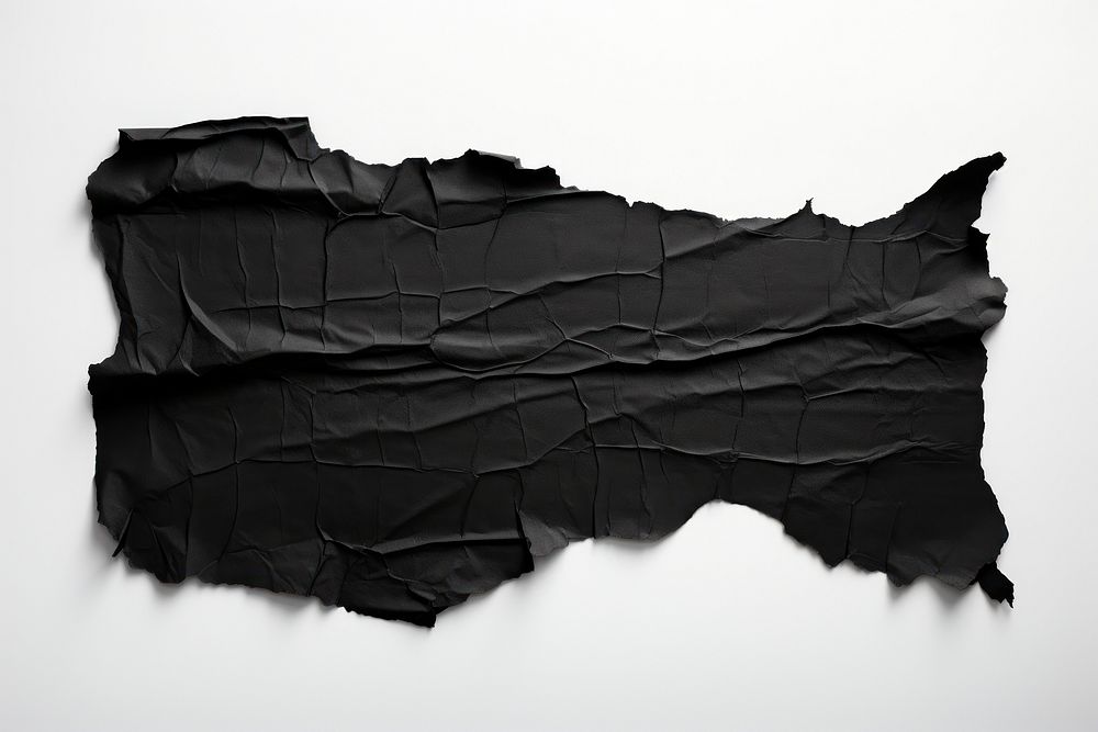 Torn strip of black paper white background monochrome crumpled.