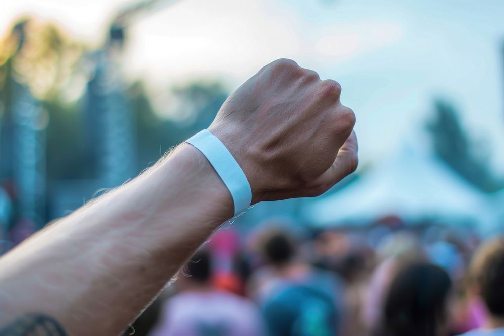 Man wearing white empty paper wristband festival outdoors finger.