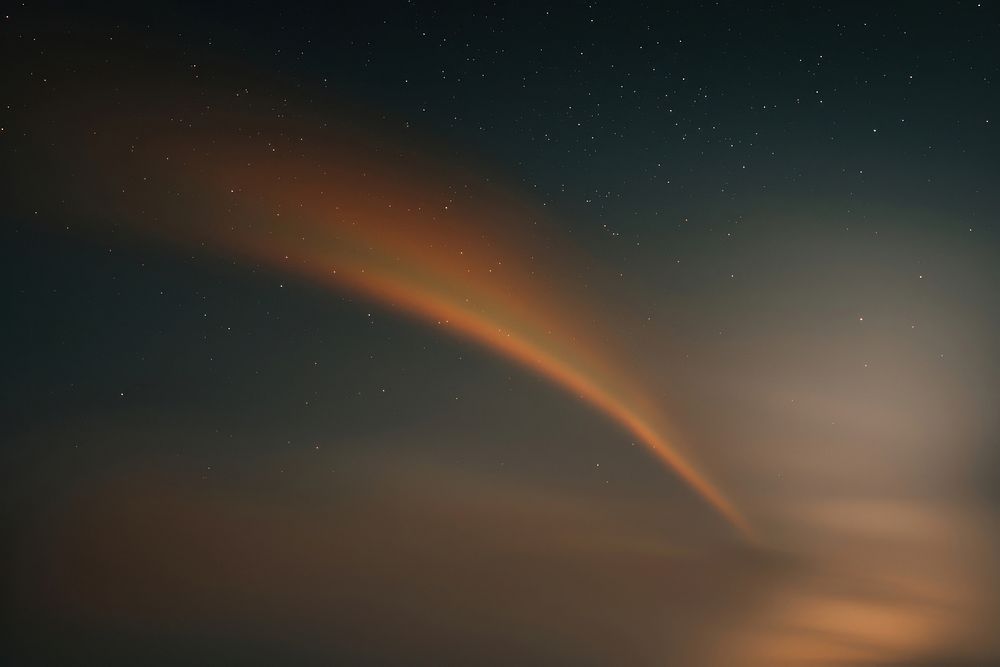 Blurred rainbow curve ray night sky astronomy.