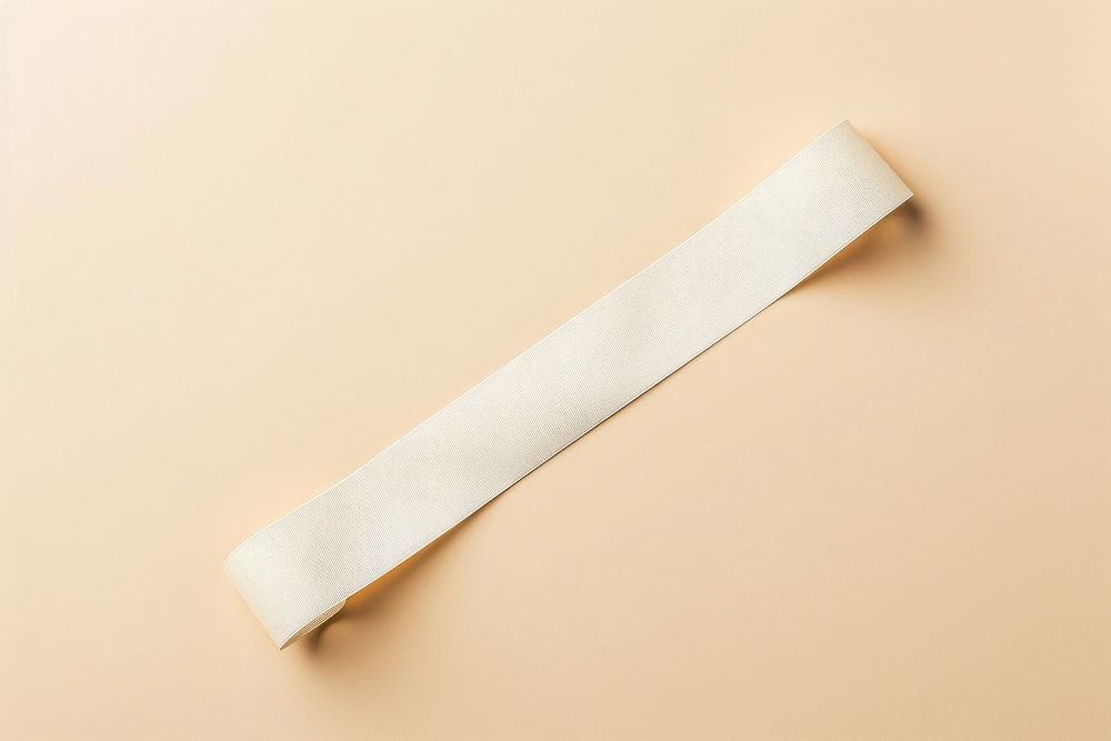 A flatlay long white empty paper wristband accessories simplicity accessory.
