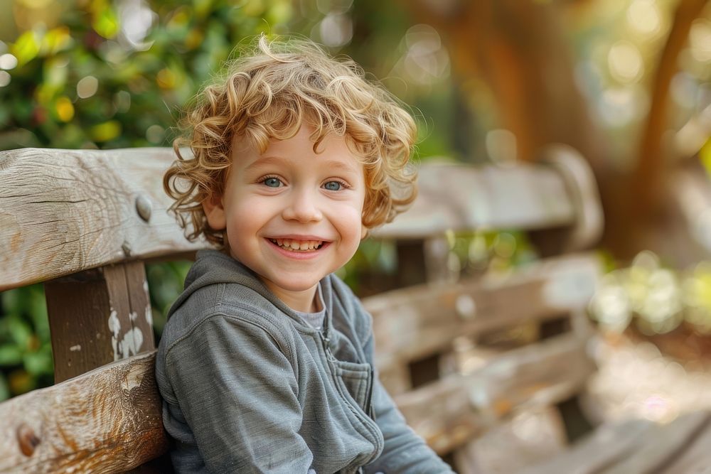 Happy boy sitting on a bench smile child relaxation.
