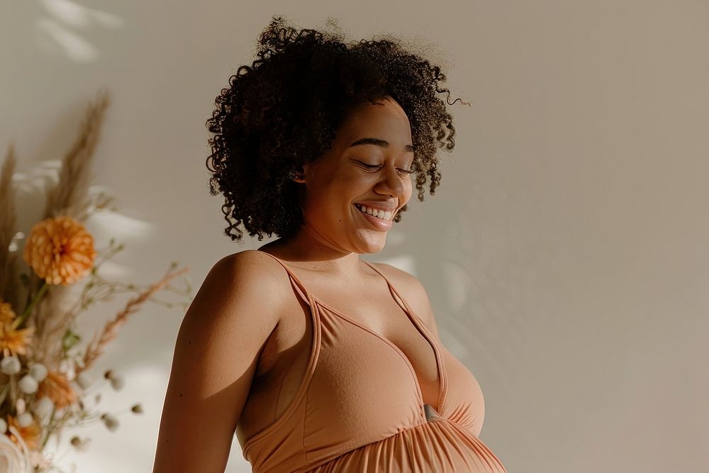 Happy pregnant black woman having a photoshoot portrait adult smile.