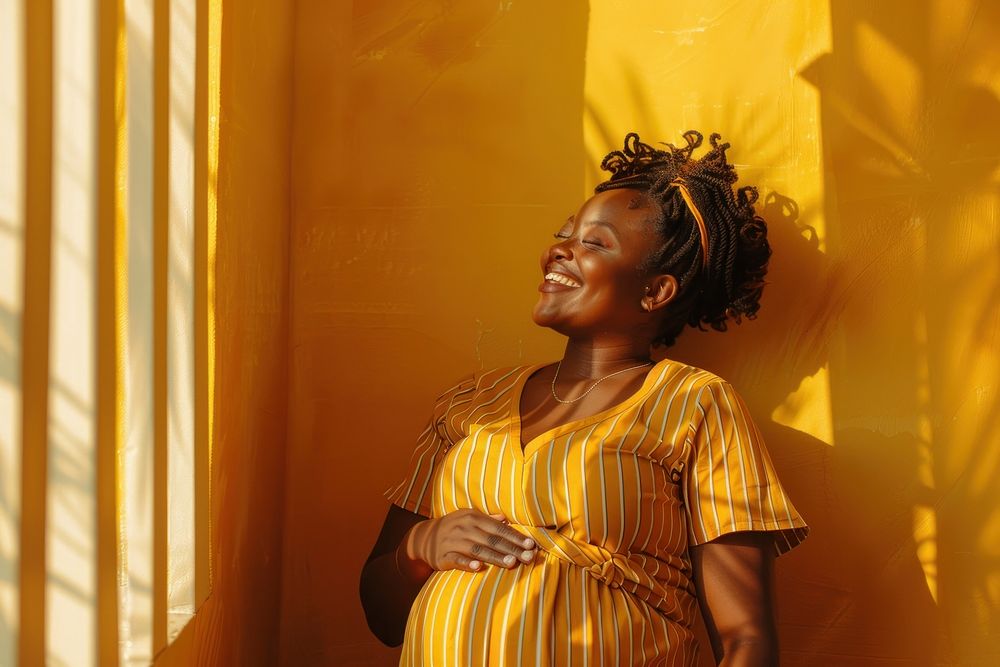 Happy pregnant black woman having a photoshoot adult anticipation architecture.