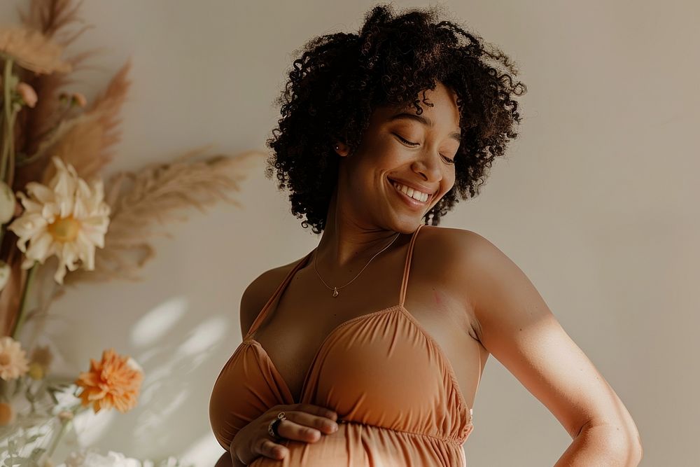 Happy pregnant black woman having a photoshoot adult smile studio shot.