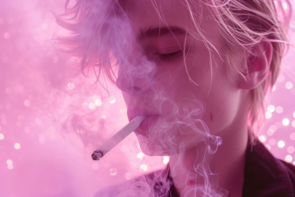 Blonde man smoking smoke pink cigarette.