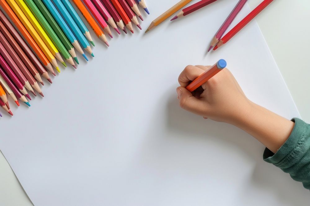 Hand child holding pencil on blank white poster writing handwriting paintbrush.