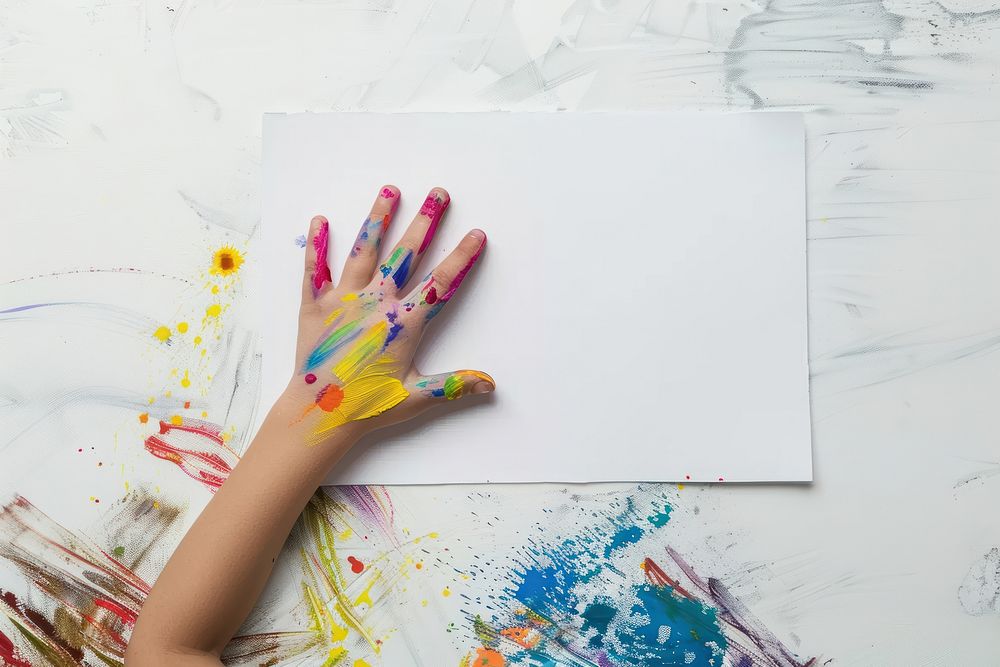 Hand child painting on blank white poster finger paintbrush creativity.