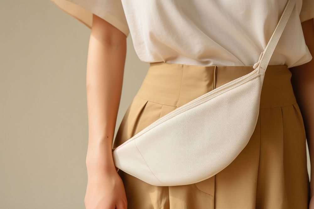 Woman carry nylon half moon crossbody bag handbag accessories midsection.