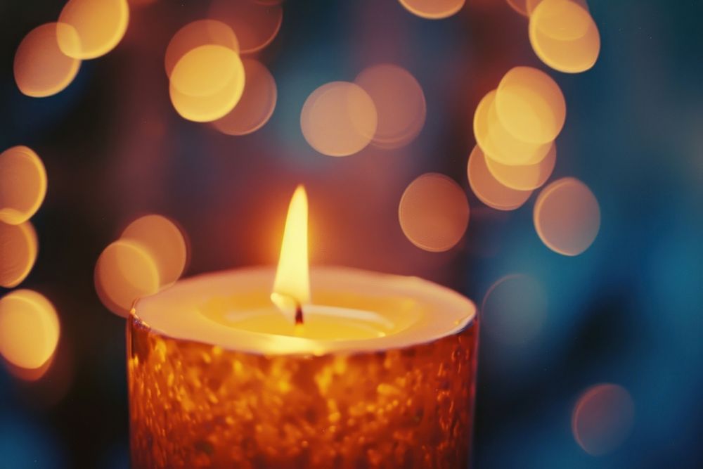 Candle light leaks fire spirituality illuminated.