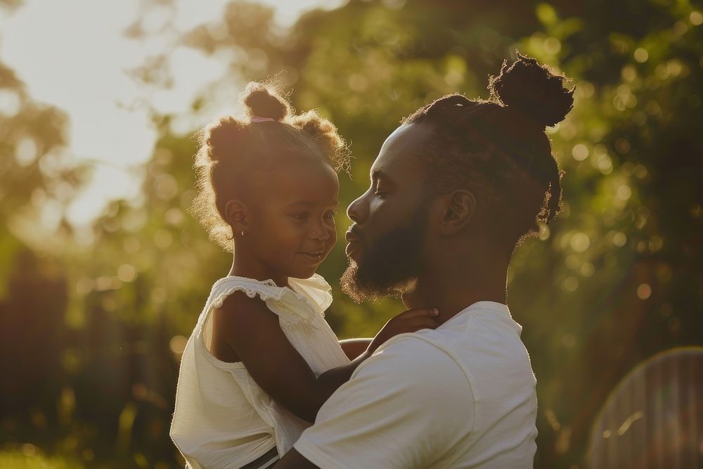 Man holding his daughter portrait outdoors nature.
