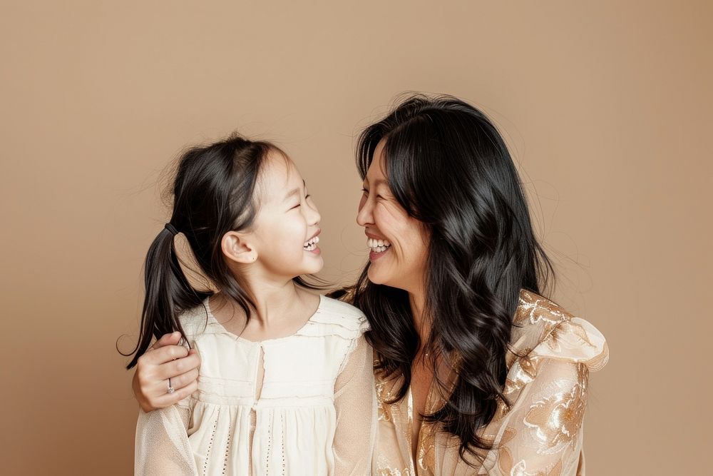 Woman laughing with her daughter child affectionate togetherness.