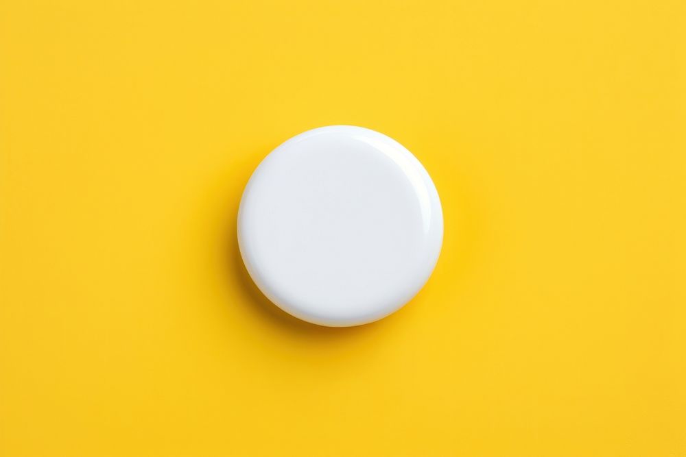 White botton pin yellow yellow background circle.