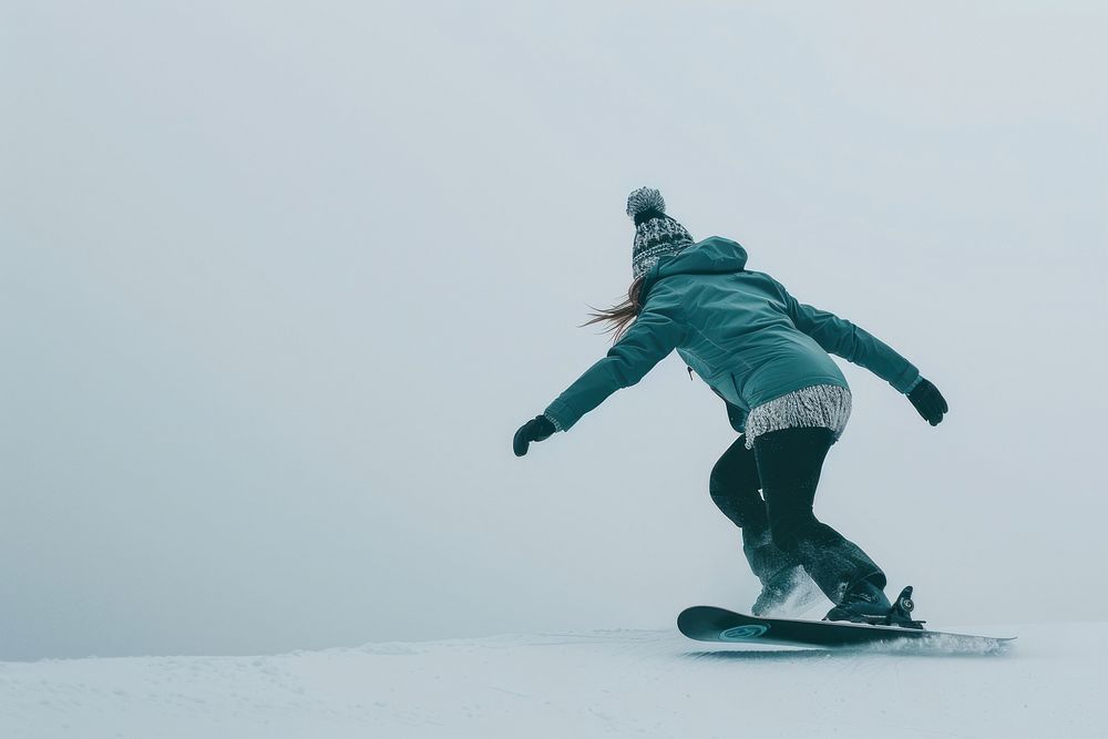Woman playing snowboard outdoors snowboarding recreation.