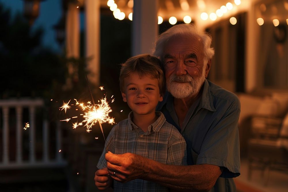 Boy and grandpa holding sparkler portrait outdoors sparks.