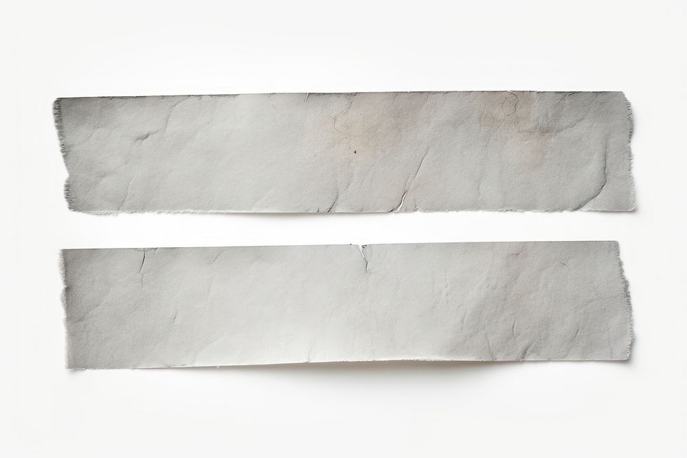 Grey adhesive strip rough paper white background.