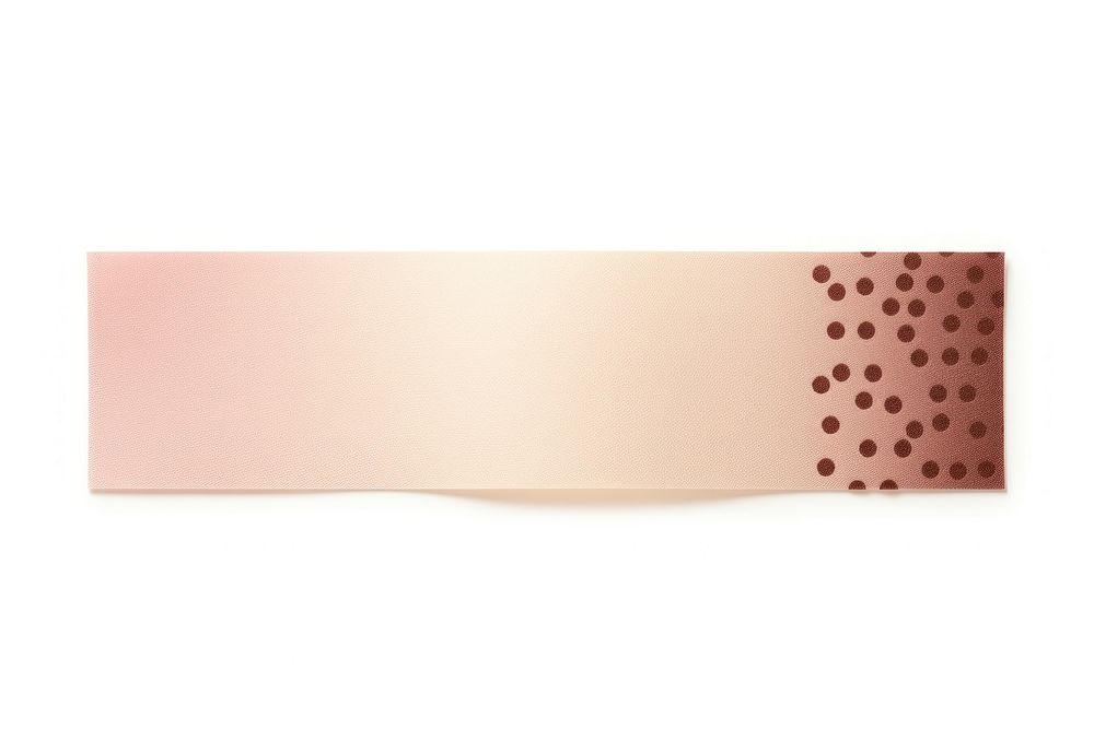 Pink and brown dot pattern adhesive strip paper white background simplicity.